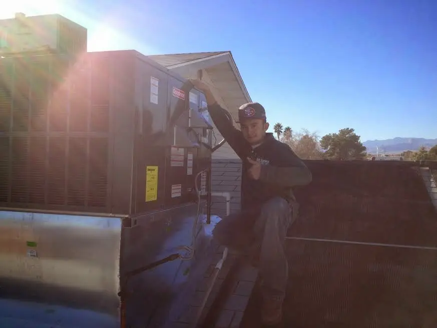 HVAC technician performing HVAC Inspection on a rooftop unit in Dawsonville